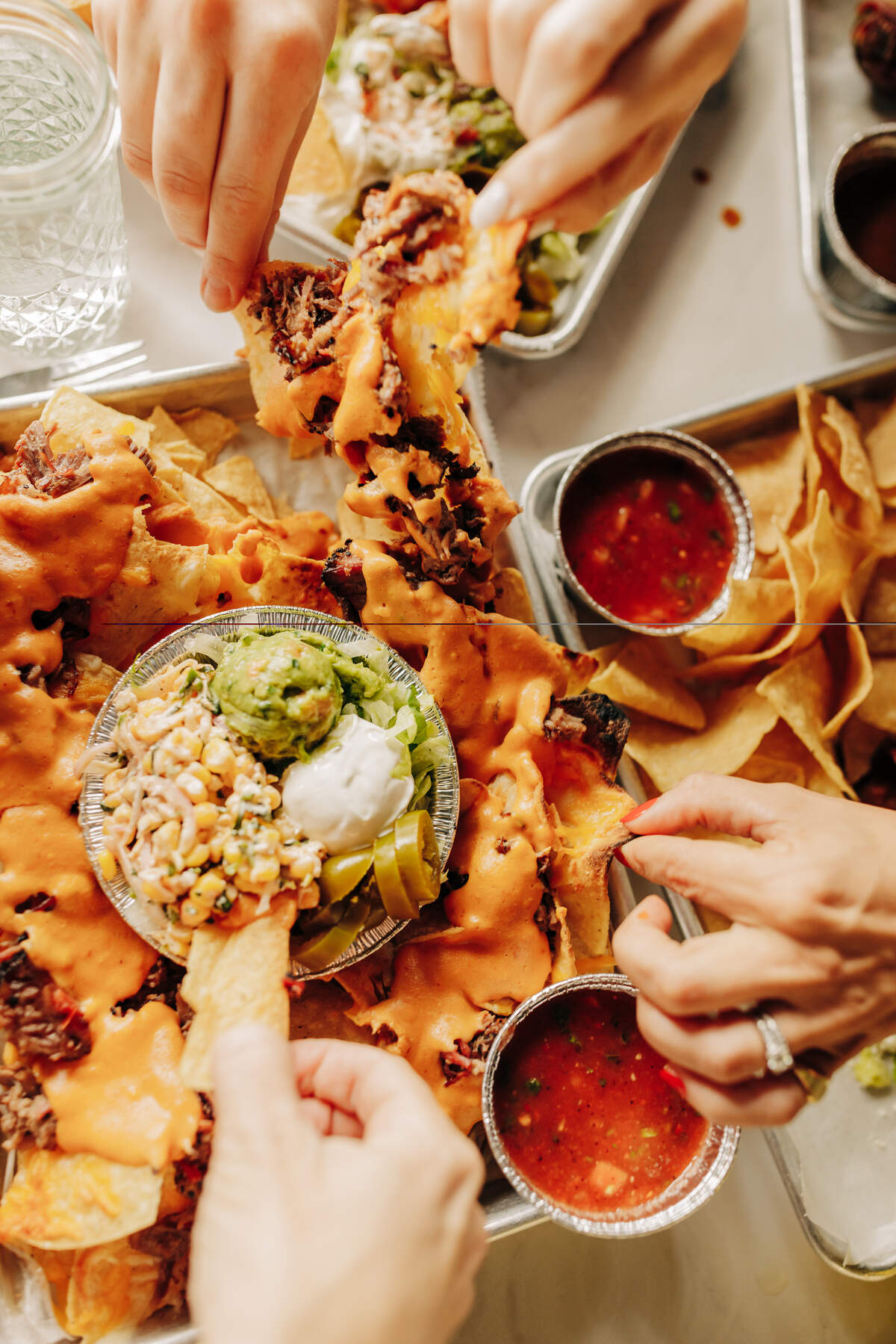 East of Texas serves nachos topped with chipotle queso and a choice of brisket, chicken, pork or veggies, served with street corn salad, salsa, shredded lettuce, sour cream, guacamole and jalapenos.